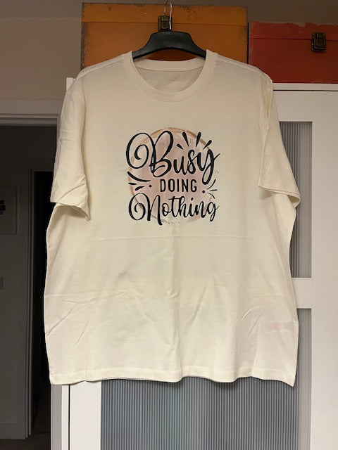 White t-shirt with 'Busy Doing Nothing' text
