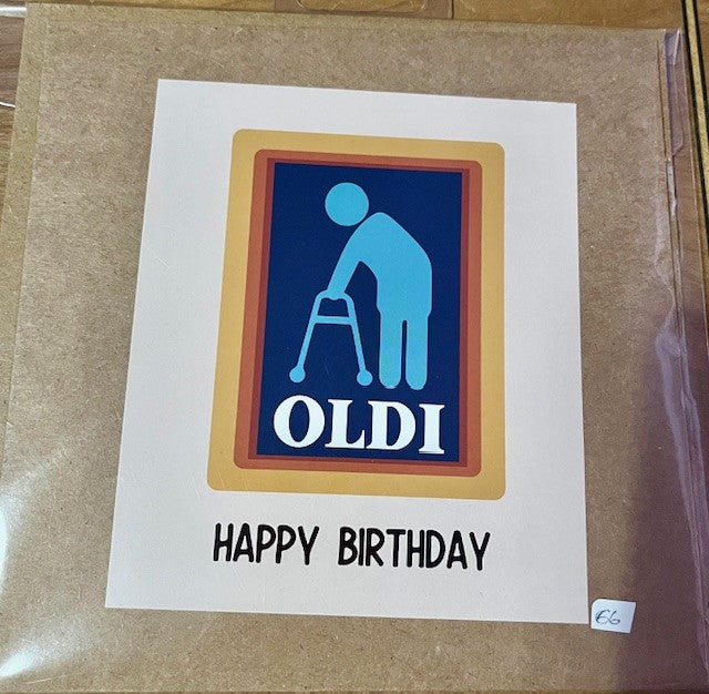 Birthday card with a humorous design on a brown surface