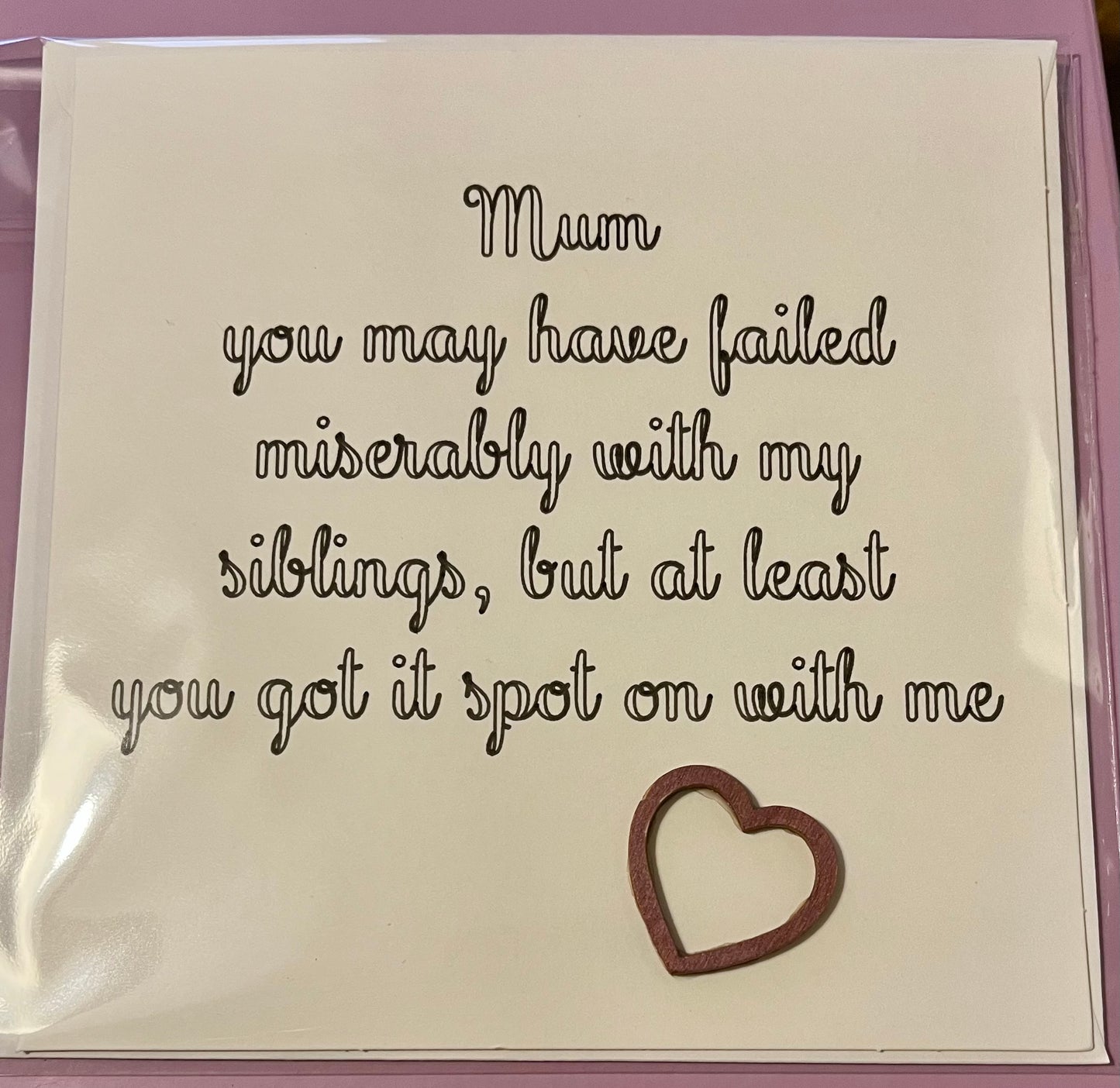 Card with humorous message for a mother, featuring a heart cutout.