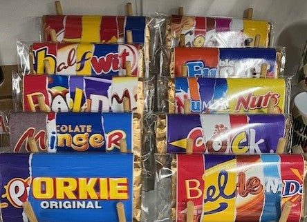 Assorted Galaxy bars displayed in a rack with colorful wrappers.