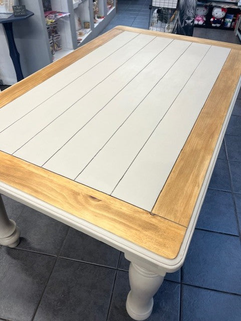 large table with wooden edge and cream painted centre and legs