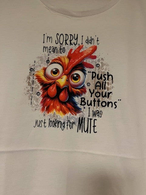 White t-shirt with a colorful rooster graphic and humorous text on a plain background