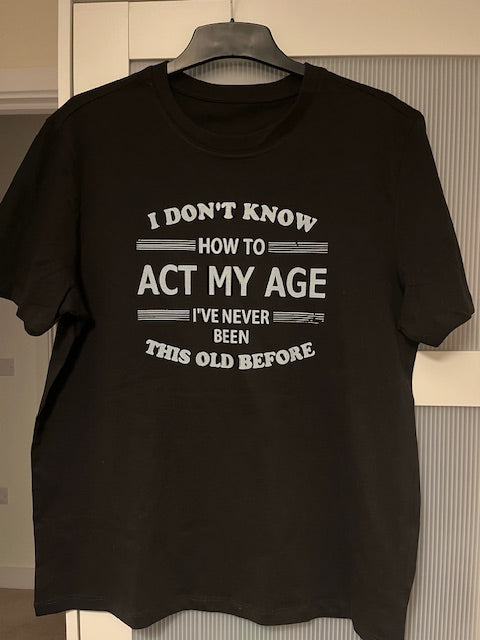 Black t-shirt with white text on a white background