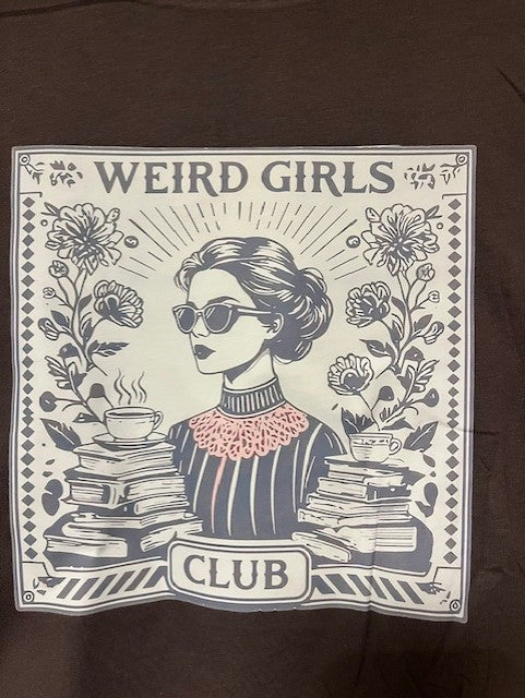 T-shirt with 'Weird Girls Club' design featuring a woman, books, and flowers on a dark grey T-shirt