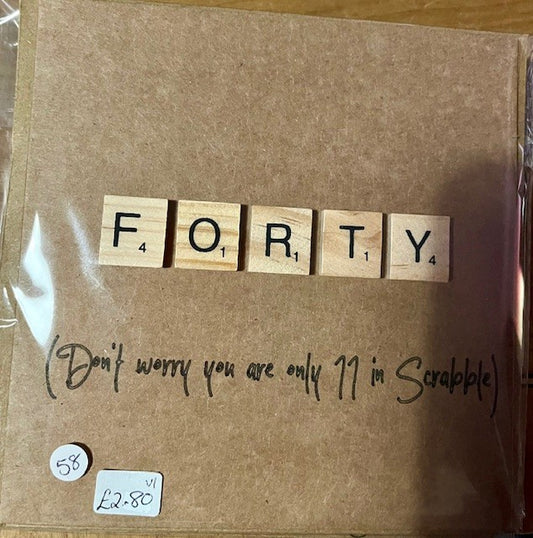 Brown greetings card with wooden letters spelling 'FORTY' and a humorous note.