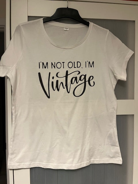 White t-shirt with 'I'm not old, I'm vintage' text 