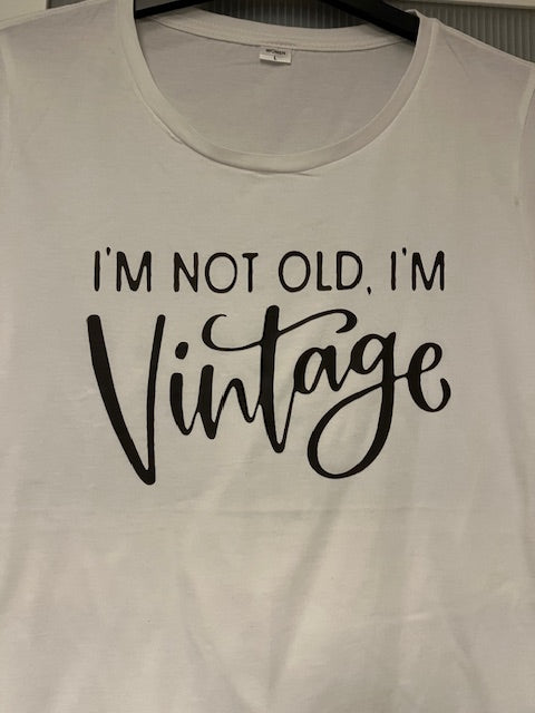 White t-shirt with black text 'I'm not old, I'm vintage' 