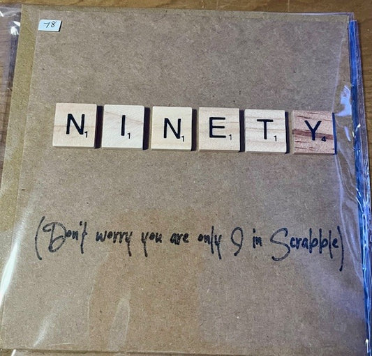 Card with 'NINETY' spelled out using Scrabble tiles and a humorous note underneath.