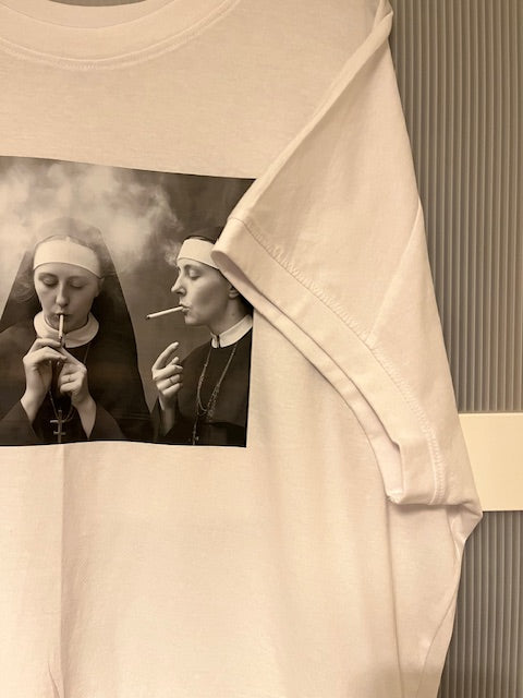 White T-shirt with a black and white graphic of smoking nuns