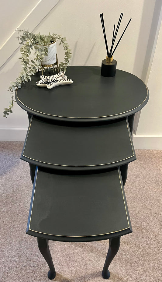 Set of three black nesting tables set to display when open
