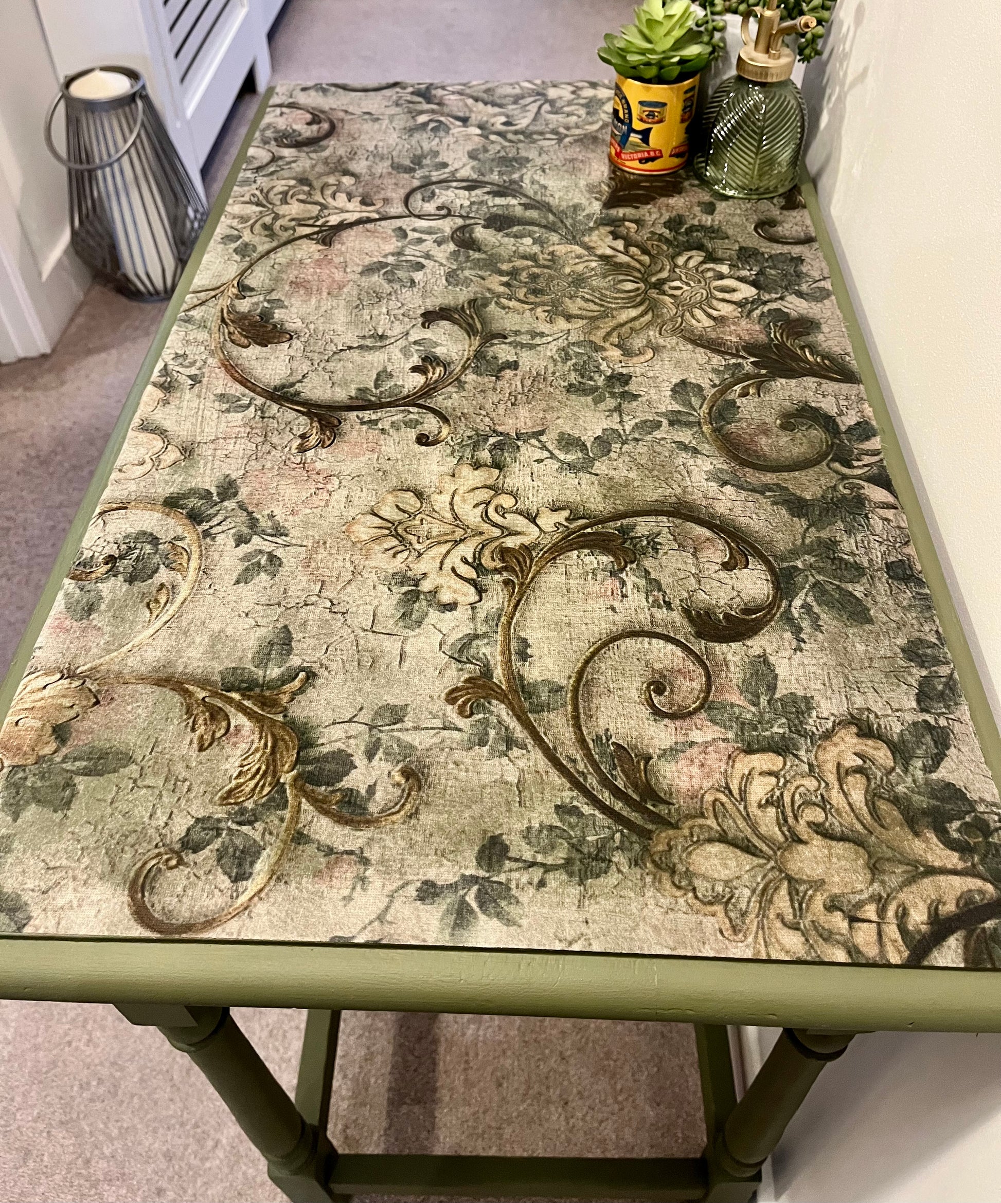 Close up of top of table, highlighting the decoupaged surface