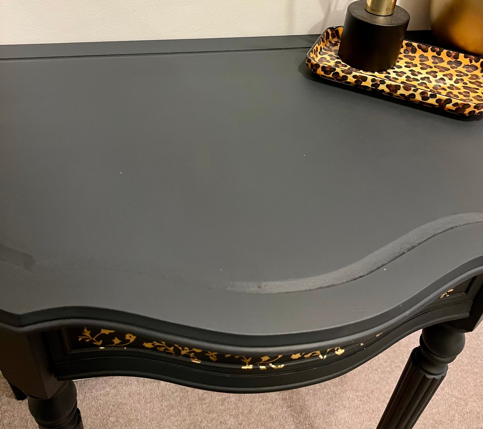 Black table top with decorative trim 