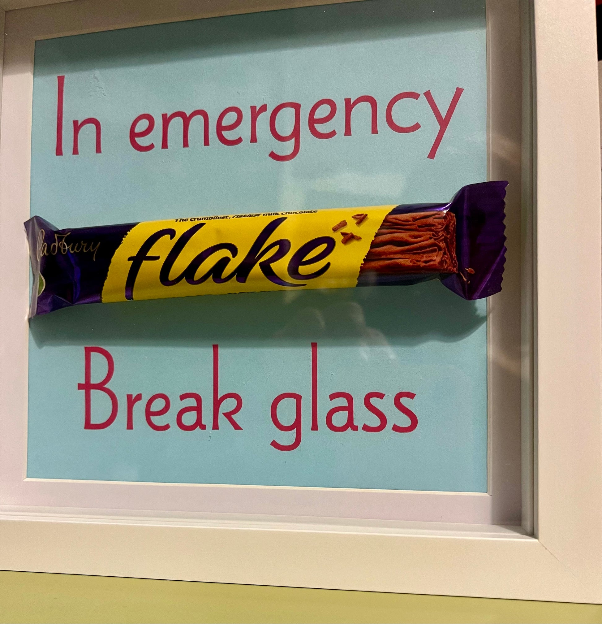 Framed candy bar with humorous 'In emergency, break glass' text