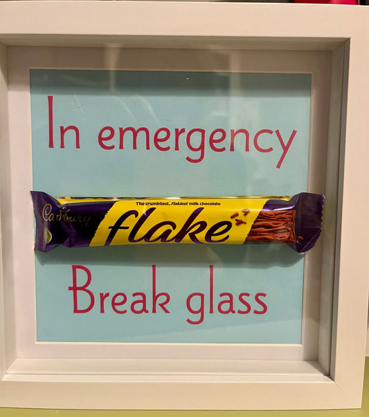 Framed chocolate bar with humorous 'In emergency, break glass' text