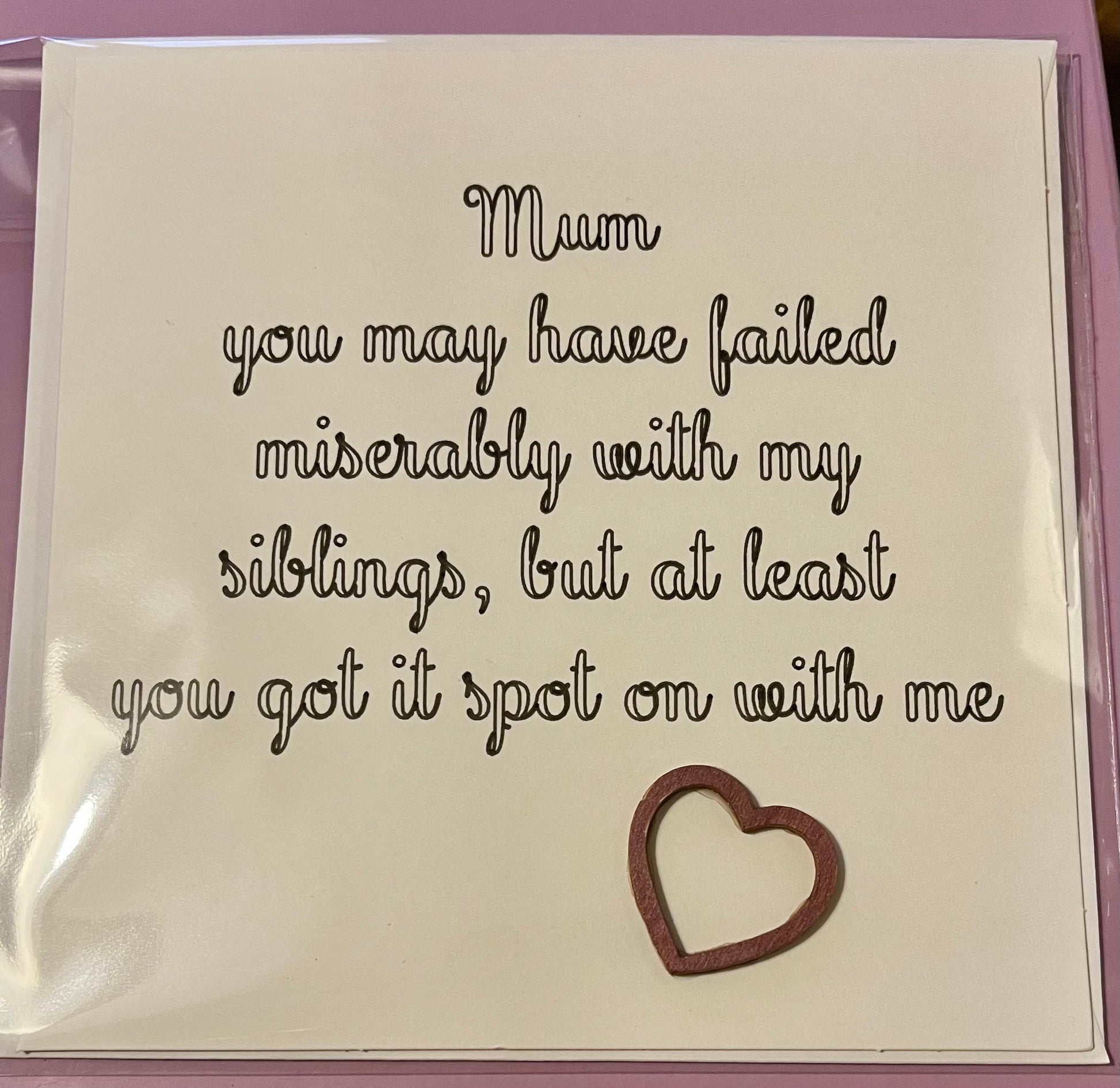Card with humorous message for a mother, featuring a heart cutout.