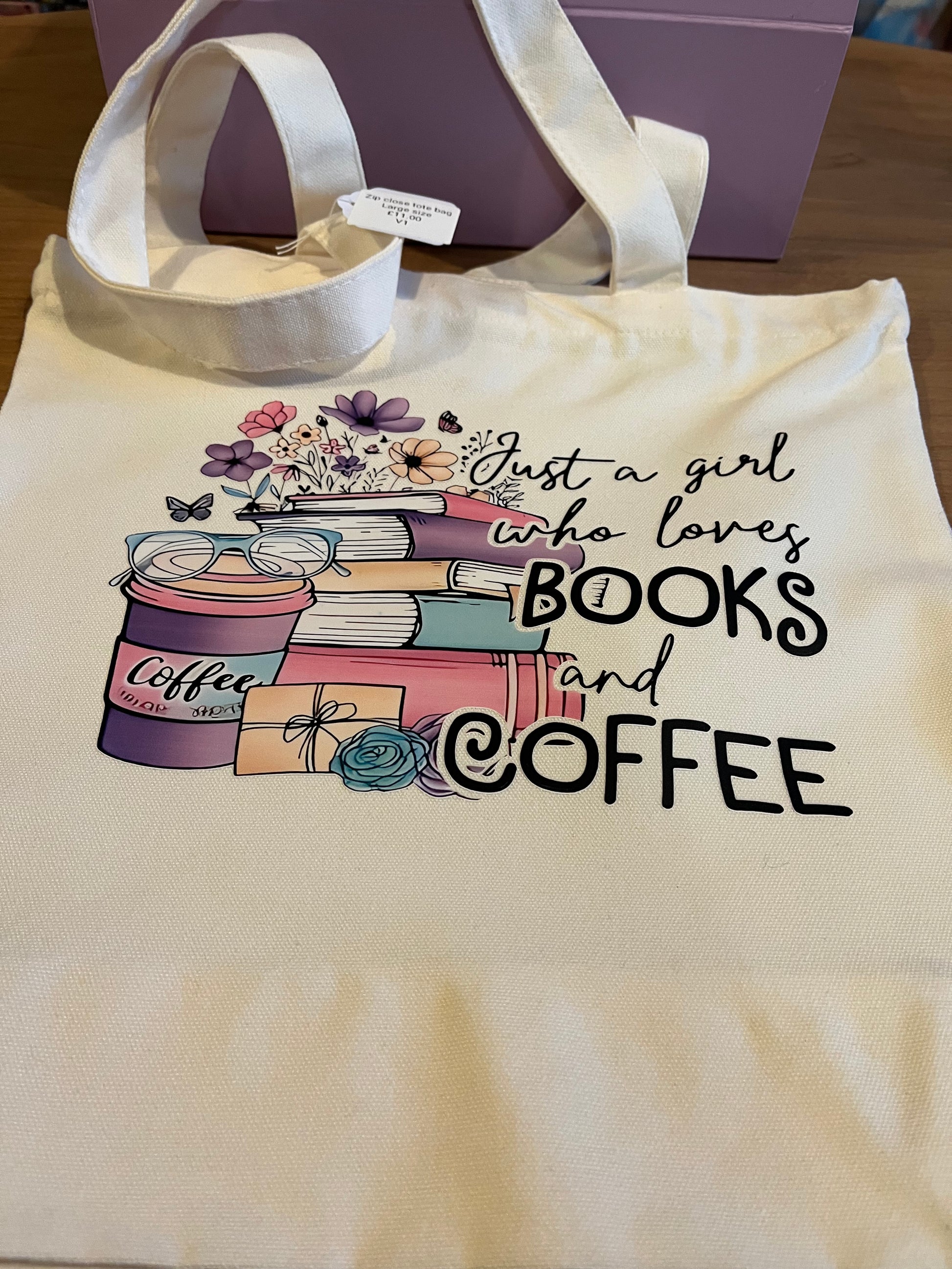 Tote bag with 'Just a girl who loves books and coffee' text and book and coffee cup illustrations. Just a girl-larger text option