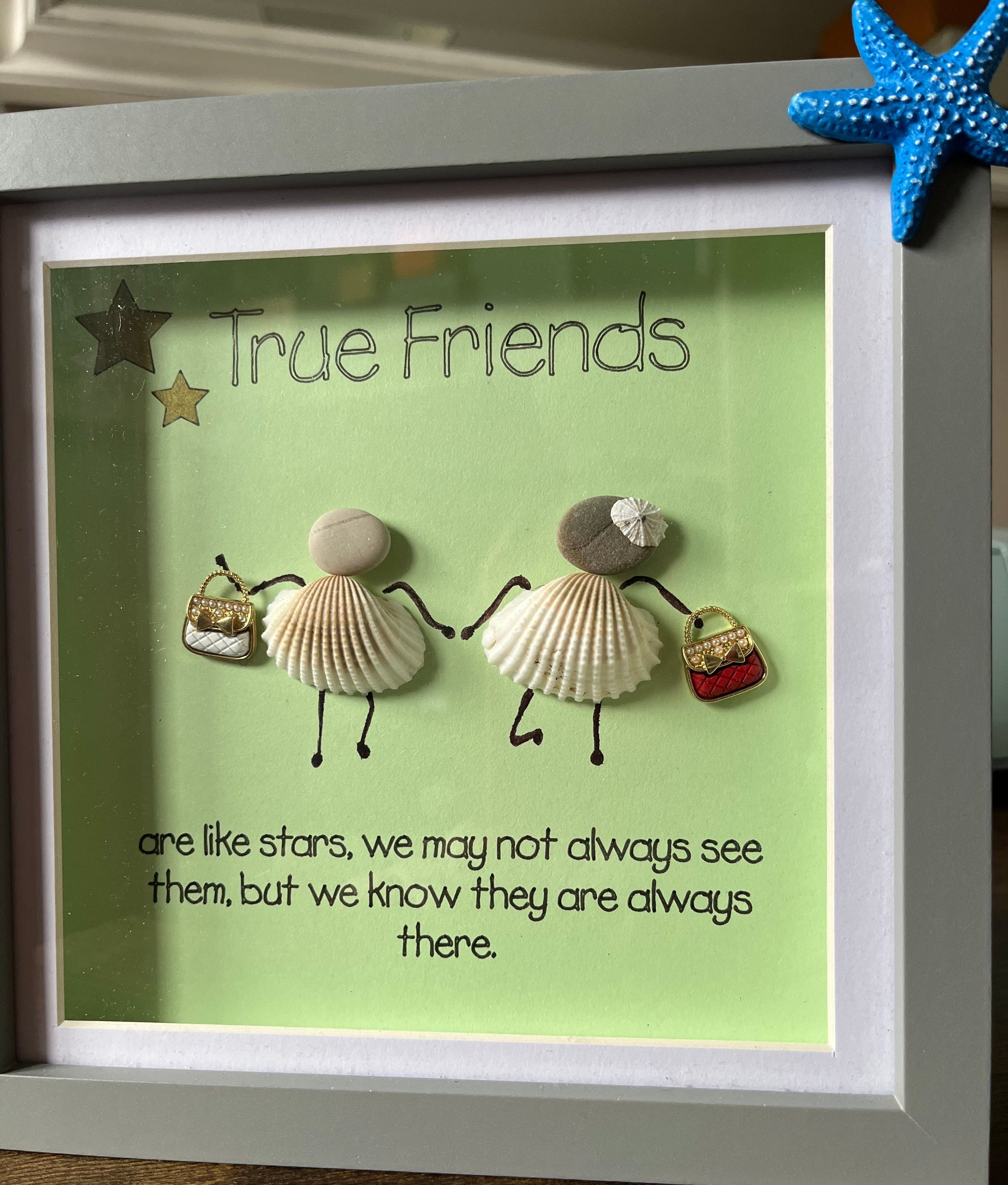 Framed artwork with seashell art and text on a green background