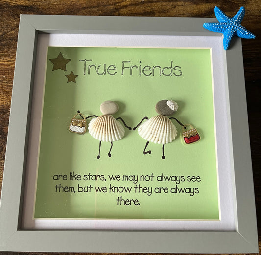 Shadowbox with shell & pebble ladies, wording True Friends are like stars, we may not always see them, but they are always there.