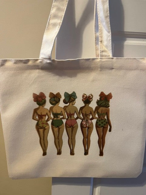 Tote bag with vintage-style illustrations of women in swimsuits on a plain background