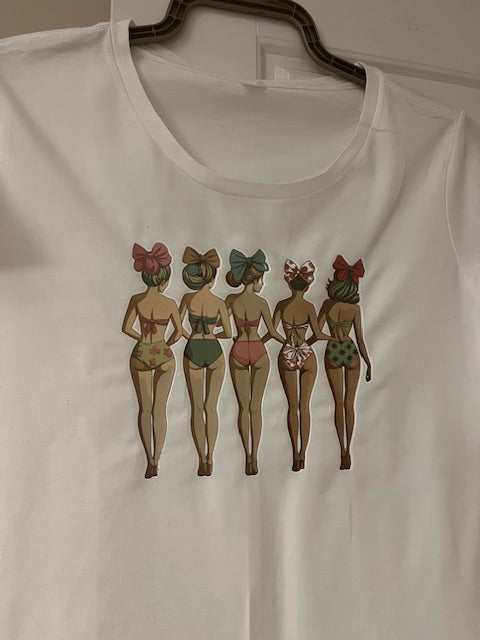 White t-shirt with vintage-style illustrations of women in swimsuits on a plain background