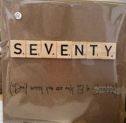 Brown paper bag with 'SEVENTY' spelled out using wooden letters, with a humorous note underneath.