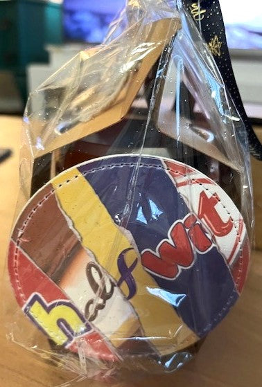 Colorful coaster and mug set with 'halfwit' on in clear plastic packaging.