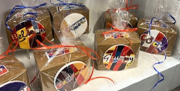 Gift sets with mugs and coasters in each box with colorful labels and ribbons