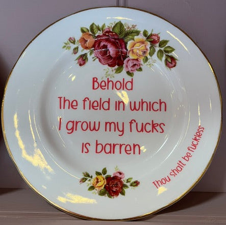 Decorative plate with floral design and text on a plain background
