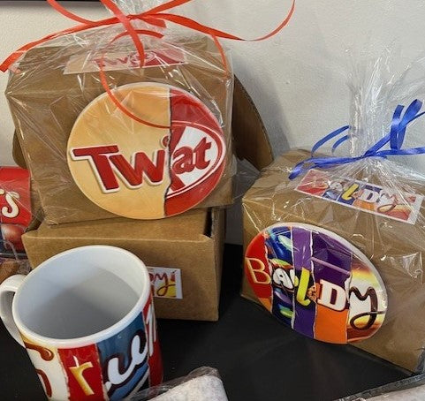 Gift boxes with chocolate wrappers wording containing mug & matching coasters.