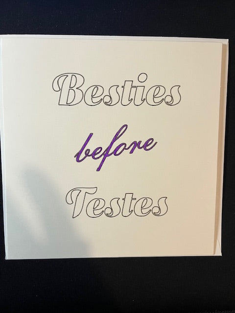 Card with 'Besties before Testes' text on a plain background